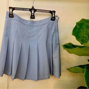 Small pleated skirt. Hits just above the knee.